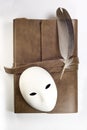 Notebook and feather and mask Royalty Free Stock Photo
