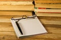 Notebook with fountain pen,glasses and books on wooden desk Royalty Free Stock Photo