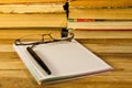 Notebook with fountain pen,glasses and books on wooden desk Royalty Free Stock Photo