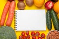 Notebook, fresh fruits and vegetables on yellow background, flat lay. Low glycemic index diet Royalty Free Stock Photo