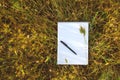 Notebook on fresh spring green grass in field