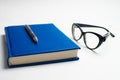 Notebook with glasses and pen, Book with glasses, Blue notebook Royalty Free Stock Photo