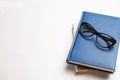 Notebook with glasses and pen, Book with glasses, Blue notebook Royalty Free Stock Photo