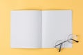 Notebook with glasses on a yellow background top view Royalty Free Stock Photo