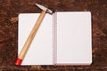 Notebook and hammer on the wooden table Royalty Free Stock Photo