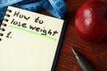 Notebook with how to lose weight sign. Royalty Free Stock Photo