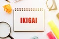 Notebook With Ikigai Next to a Magnifying Glass