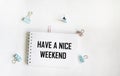 A notebook with the inscription Have a nice weekend, on a white background Royalty Free Stock Photo