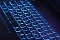 Notebook keyboard with dark blue light tint, technology concept