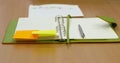 Notebook in a light green cover pen and two stickers Royalty Free Stock Photo