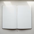A notebook with lined pages, open flat on a light wooden surface. Soft natural light enters from Royalty Free Stock Photo