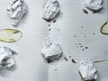 Damaged notebook with scattered paper balls, reflecting stress, exhaustion, and creative collapse Royalty Free Stock Photo