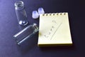 Notebook and medicine bottles on a black background