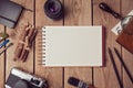 Notebook mock up for artwork or logo design presentation with film camera and lens. View from above Royalty Free Stock Photo