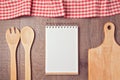 Notebook mock up template with kitchen utensils and tablecloth. View from above