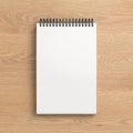Notebook mockup. Blank workplace notebook. Spiral notepad on wooden background Royalty Free Stock Photo