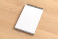 Notebook mockup. Blank workplace notebook. Spiral notepad on wooden background Royalty Free Stock Photo