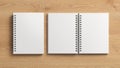 Notebook mockup. Closed and open blank notebook with white cover. Spiral notepad on wooden background Royalty Free Stock Photo