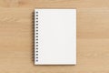 Notebook mockup. Opened blank notebook with craft paper cover. Spiral notepad on wooden background Royalty Free Stock Photo