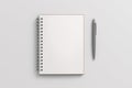 Notebook mockup. Opened blank notebook and pen. Spiral notepad on white background