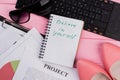 Notebook with motivation words on bright pink background with cute feminine accessories sunglasses women`s shoes. Royalty Free Stock Photo