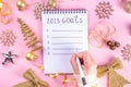 Notebook with New`s Year Resolutions massage, with Christmas ornaments and decor. New Year goals List 2023, plan listing of new