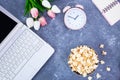 Notebook Notepad Alarm Clock Bouquet of tulips Popcorn in a bowl on the desktop