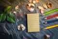 A notebook for notes with crayons and pencils. Pencil sharpener placed on a table made of stone. Using image for education with b Royalty Free Stock Photo