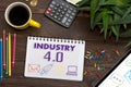 Notebook with a notes INDUSTRY 4.0 on the office table with tools. Concept with elements of infographics Royalty Free Stock Photo