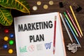 Notebook with a notes MARKETING PLAN on the office table Royalty Free Stock Photo