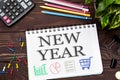 Notebook with a notes NEW YEAR on the office table with tools. C Royalty Free Stock Photo