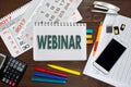 Notebook with a notes WEBINAR on the office table with tools Royalty Free Stock Photo