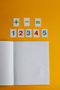 Notebook, numbers on a yellow background. Accessories for study. Mathematics, geometry, algebra