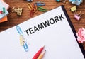 Notebook on office table with TEAMWORK text. Business conept