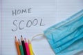 Notebook open in a ruler colored pencils and a medical mask on the school desk, home education Royalty Free Stock Photo