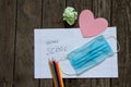 Notebook open in a ruler colored pencils and a medical mask on the school desk, home education Royalty Free Stock Photo