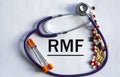 Notebook pade with acronym RMF on a table with a stethoscope and pills