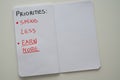 Notebook page, with text `priorities: spend less, earn more` Royalty Free Stock Photo