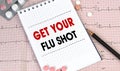 Notebook page with words - Get Your Flu Shot nearby with a pills and pencil, medical concept Royalty Free Stock Photo