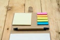 Notebook paper, post it and pen top view on wood pallet Royalty Free Stock Photo