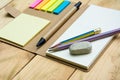 Notebook paper, post it and pen top view on wood pallet Royalty Free Stock Photo