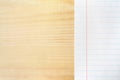 Notebook paper on a wooden table. Lined paper background with free text space.