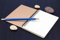 Notebook, Pebble Beach and blue pencil Royalty Free Stock Photo