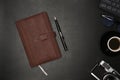 Notebook, pen and camera on black leather. Royalty Free Stock Photo