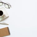 Notebook, pen, cup of coffee, glasses on white background Royalty Free Stock Photo