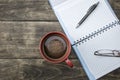 Notebook pen and cup of coffee on wood table Royalty Free Stock Photo
