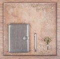 Notebook and pen and delicate bouquet on a wooden background.