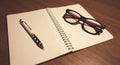 Notebook with pen and glasses.