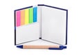 Notebook with colorful page marker stickers and a pen