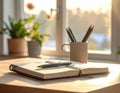 Notebook pen plants sunlight workspace Royalty Free Stock Photo